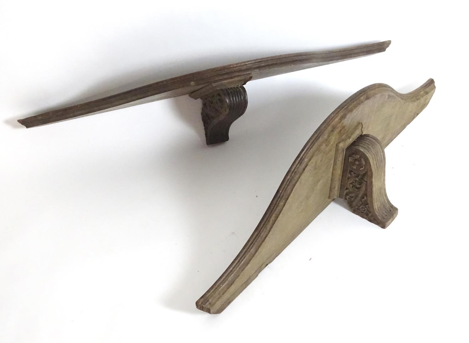 A pair of large 19thC oak wall brackets of serpentine form, each measuring 42" wide, 7 1/2" tall,