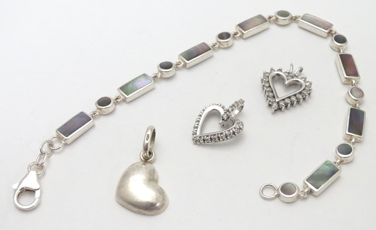 A silver bracelet set with abalone shell detail together with and 3 assorted charms (4) Please - Image 3 of 8