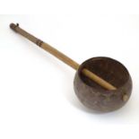 Ethnographic / Native / Tribal: A late 19th / early 20thC ladle with a carved handle incised with