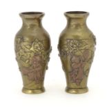 A pair of late 19th / early 20thC miniature brass vases with engraved and relief decoration