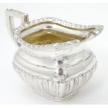 A silver cream jug, hallmarked Birmingham 1910, maker William Aitken. Approx. 2 3/4" high Please