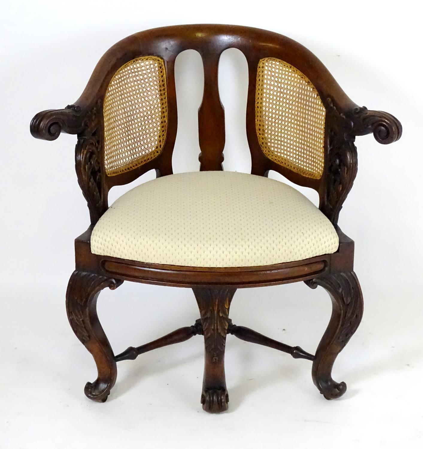 A 19thC mahogany Bürgermeister chairs with scrolled carved arms, double caned backrests and having