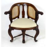 A 19thC mahogany Bürgermeister chairs with scrolled carved arms, double caned backrests and having