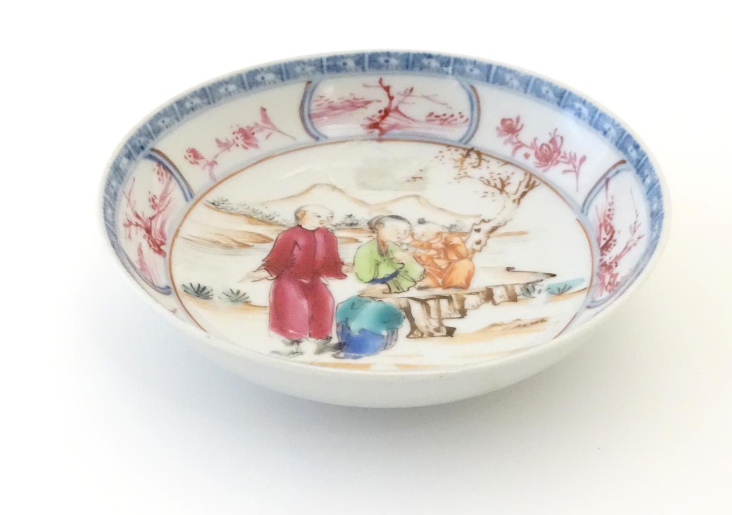 An Oriental famille rose dish depicting a mountainous landscape scene with two figures and a child - Image 4 of 5