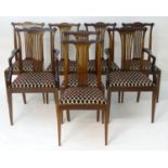 A set of eight early 20thC mahogany dining chairs by Druce & Co. The chairs having shaped cresting