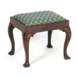 A George I mahogany cabriole leg stool of peg jointed construction, having a drop in seat above