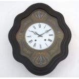 A 19thC French vineyard wall clock, the ebonised case with glazed panel over ebony, brass and