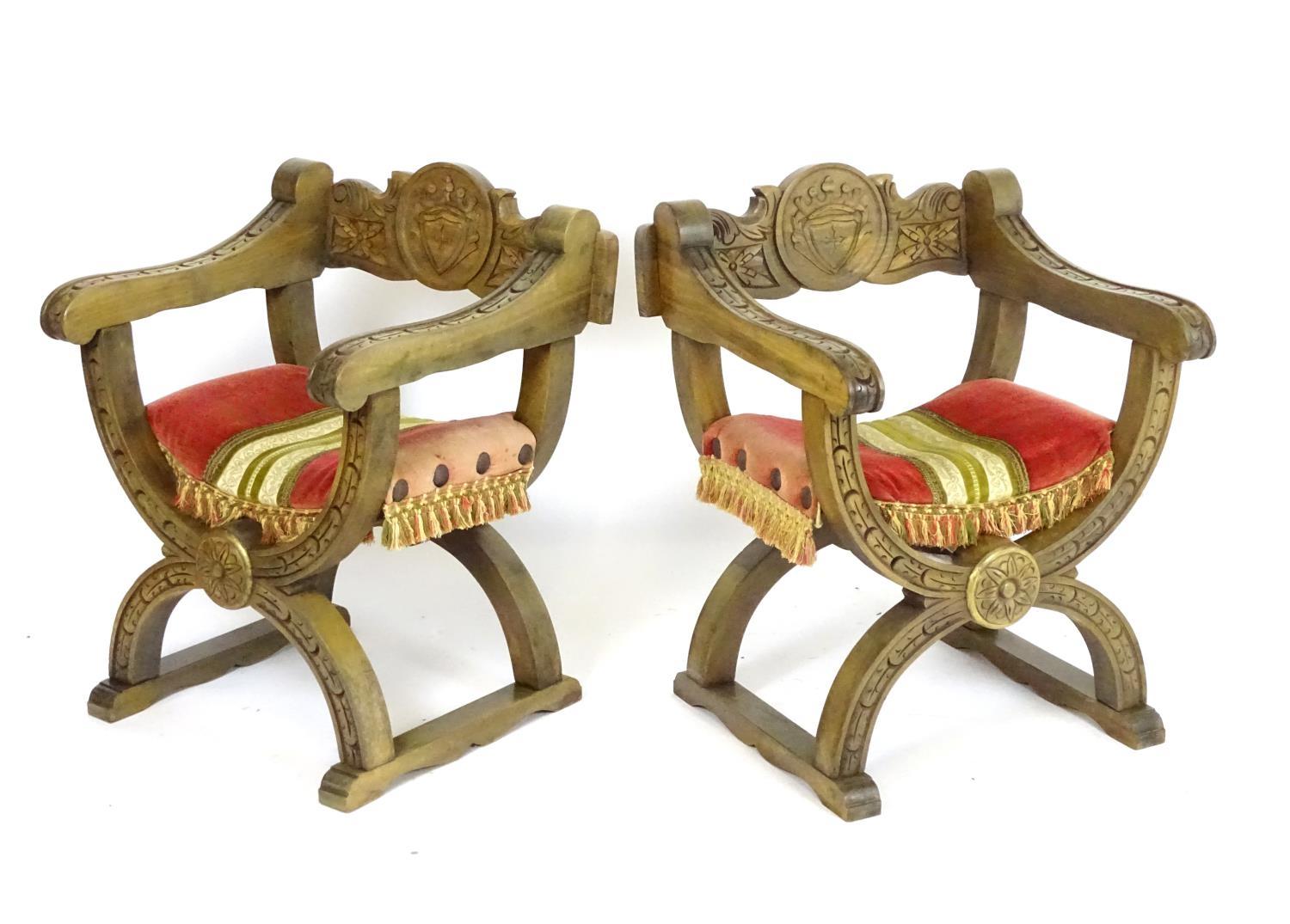A pair of vintage Savonarola chairs with carved and moulded X-frames. 23" wide x 21" deep x 29"