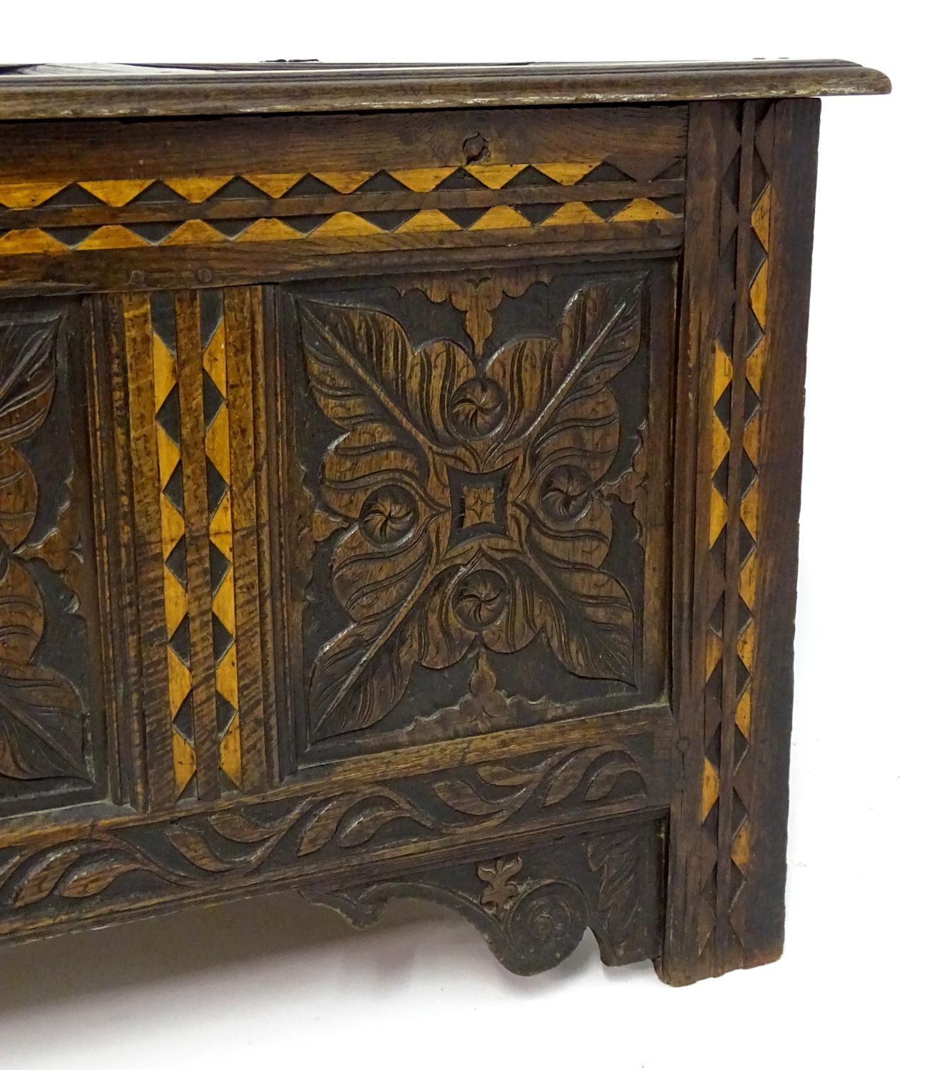 A 17thC oak three panel coffer with a moulded lid above carved panelling to the front with floral - Bild 11 aus 11