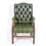 A late 20thC leather Gainsborough chair with deep buttoned leather upholstery and a mahogany