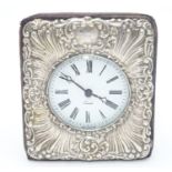 An easel back clock with silver surround. Hallmarked London 1990 maker Keyford Frames Ltd. 4 1/2"