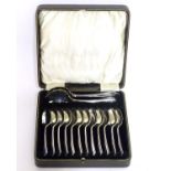 A cased silver set of 12 spoons and 2 servers