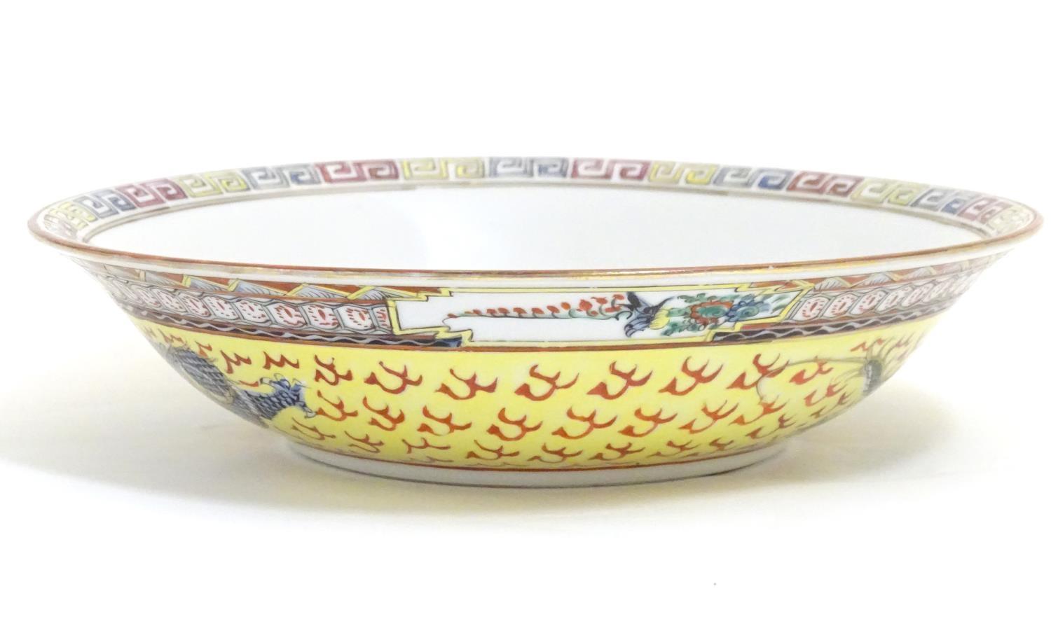 A Chinese famille jeune bowl decorated with two dragons and patterned border. Character marks under. - Image 7 of 7