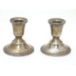 A pair of sterling silver squat candlesticks with weighted bases. Marked Duchin Creation under.