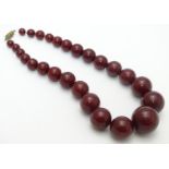 A vintage necklace of graduated cherry amber Bakelite beads. Approx 15" long. Largest bead approx