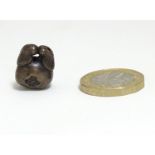 A Japanese ojime bead formed as a stylised crab. Approx. 5/8" Please Note - we do not make reference