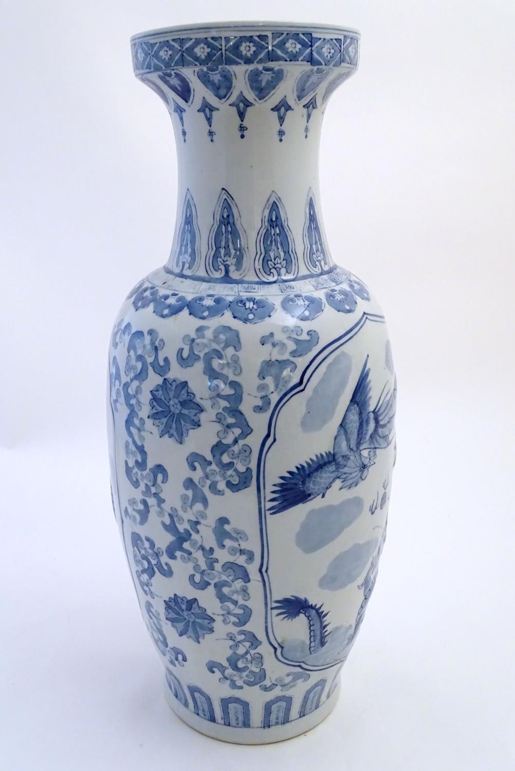 A large Chinese blue and white vase decorated with flowers, foliage and a stylised phoenix and - Image 3 of 10