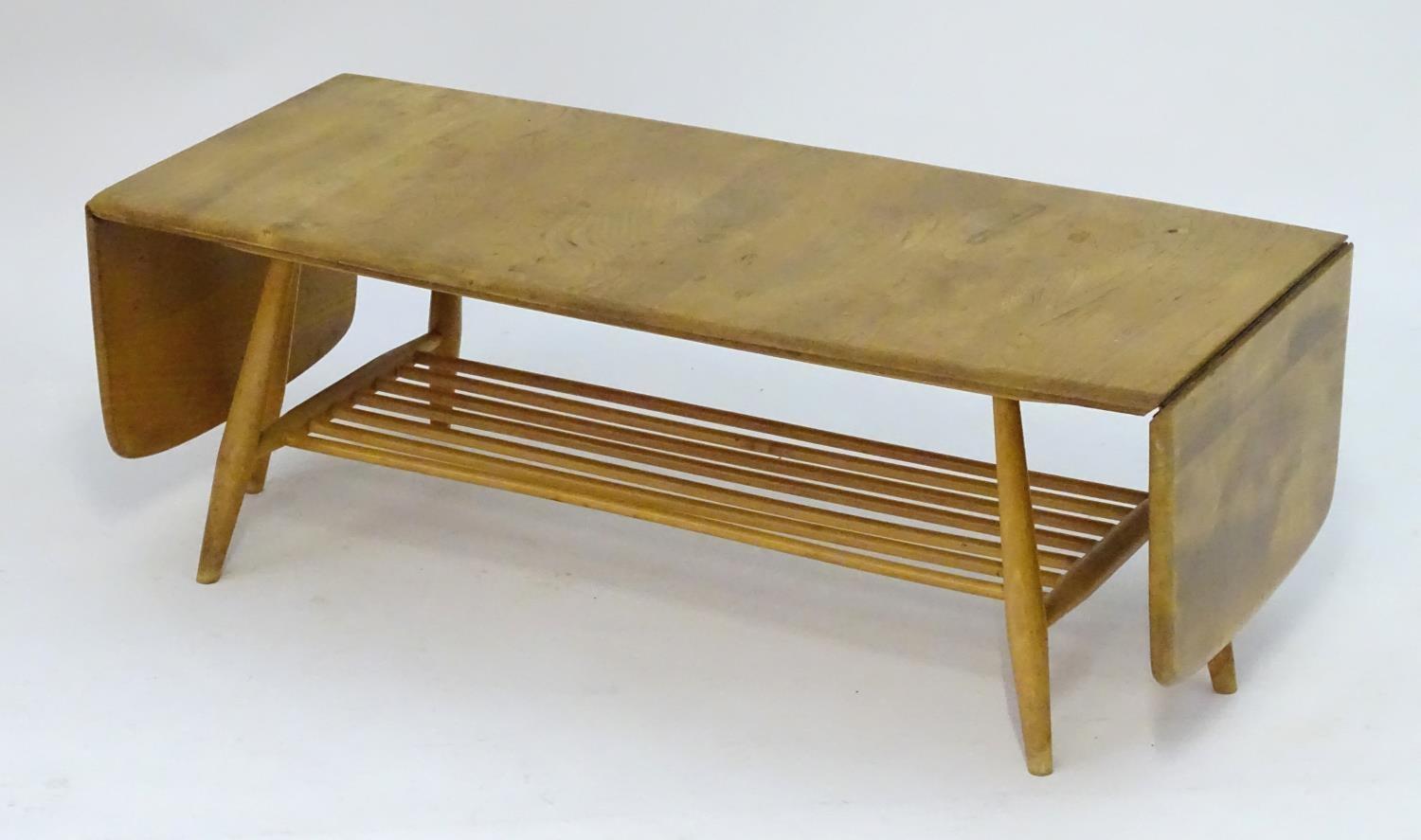 Vintage Retro, Mid-Century: an Ercol elm and beech coffee table, extending with drop flaps, standing