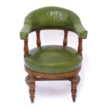 C.1900 oak swivel armchair / captains chair with a shaped green leather upholstered backrest and