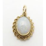 A 9ct pendant set with opal cabochon Approx 1/2" long Please Note - we do not make reference to