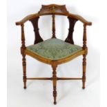 A late 19thC / early 20thC corner chair with a marquetry inlaid cresting rail and decoratively