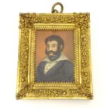 A 19thC oil on board portrait miniature depicting a gentleman wearing a blue jacket, a wide collared