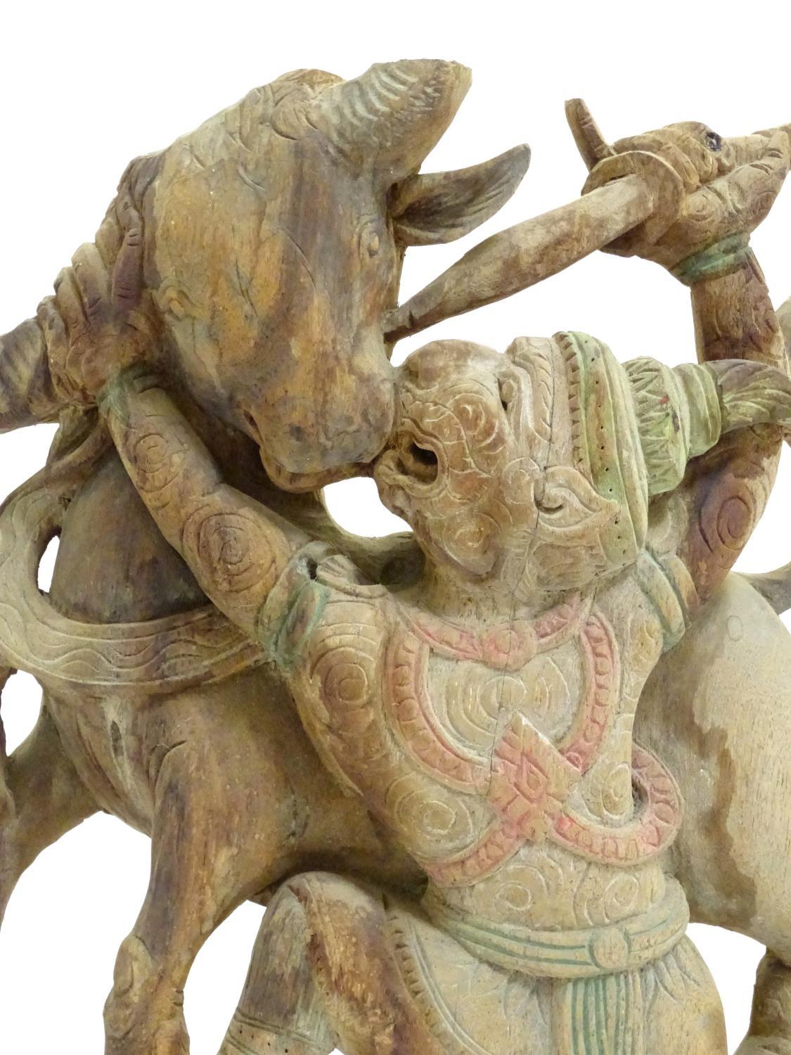 An Asian 20thC carved wooden sculpture modelled as a bull and warrior with polychrome decoration. - Image 3 of 8