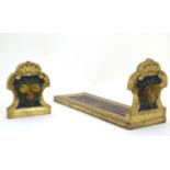An Italian style carved book slide with gilt and polychrome decoration, the supports decorated