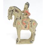 A Chinese model of a figure on horseback with polychrome decoration. Approx. 9 1/2" high Please Note