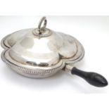 A silver plate serving dish and cover of trefoil form with three sections within and having ebonised