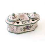 A Continental faience standish with two lidded inkwells and floral and foliate detail. Approx. 3 1/