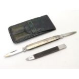 A green leather pouch containing a file and folding twin blade knife, marked 'Silver'. The case 23/