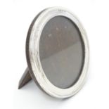 A photograph frame of circular form with silver surround hallmarked Bimringhm1925 maker Sanders &