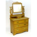 A late 19thC / early 20thC walnut dressing table with a mirror mounted on pierced supports, the base