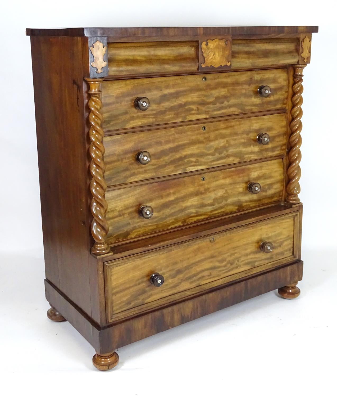 A mid 19thC mahogany north country chest of drawers comprising two short cushion drawers over four