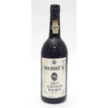 A 75cl bottle of Warre's 1977 vintage port, 11 1/4" tall Please Note - we do not make reference to