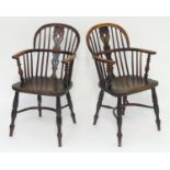 A pair of early 19thC double bow back Windsor chairs of yew, beech and elm construction. With