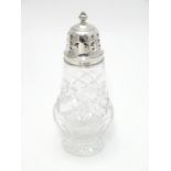 A silver mounted cut glass sugar sifter. Hallmarked Birmingham 1960 maker Adie Bros Ltd. 6" High