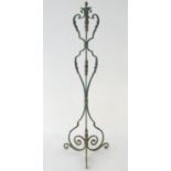 A late 19th / early 20thC wrought iron standard lamp with a verdigris finish and gilt foliate