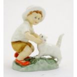 A Royal Worcester figure, Snowy, modelled as a child with a white cat . Marked under with title,