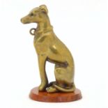 A late 19th / early 20thC brass model of a seated dog on a circular hardstone base. Approx. 2 1/2"