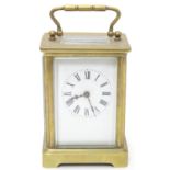 A 20thC brass cased carriage clock / timepiece . 5 1/2" high overall. Please Note - we do not make