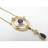 A 15ct gold pendant and chain, the pendant with amethyst and seed pearl decoration. Approx. 19" long