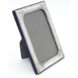 An Irish photograph frame with silver surround having Celtic-style designs at each corner.