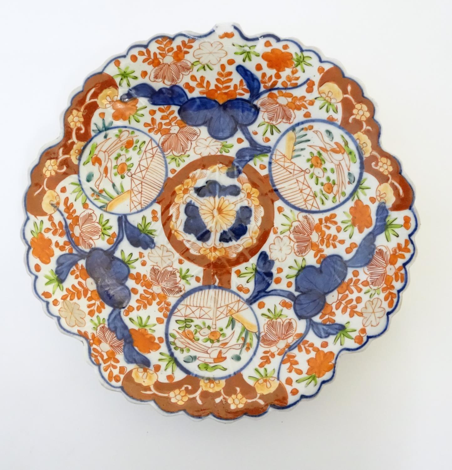 A Japanese Imari plate with a scalloped rim with stylised leaf veins in relief to the centre, - Image 9 of 9