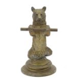 A Victorian novelty brass desk inkwell / standish modelled as a standing bear holding a staff, his