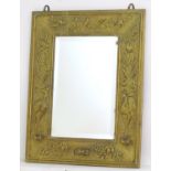 A late 19thC Aesthetic movement mirror / girandole with a brass embossed frame and bevelled edge.
