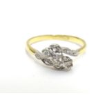 An 18ct gold ring set with trio of platinum set diamonds to top. Ring size approx M 1/2 Please