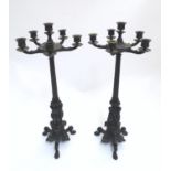 A pair of Regency bronze candelabra, the fluted columns supporting a series of five candle cups