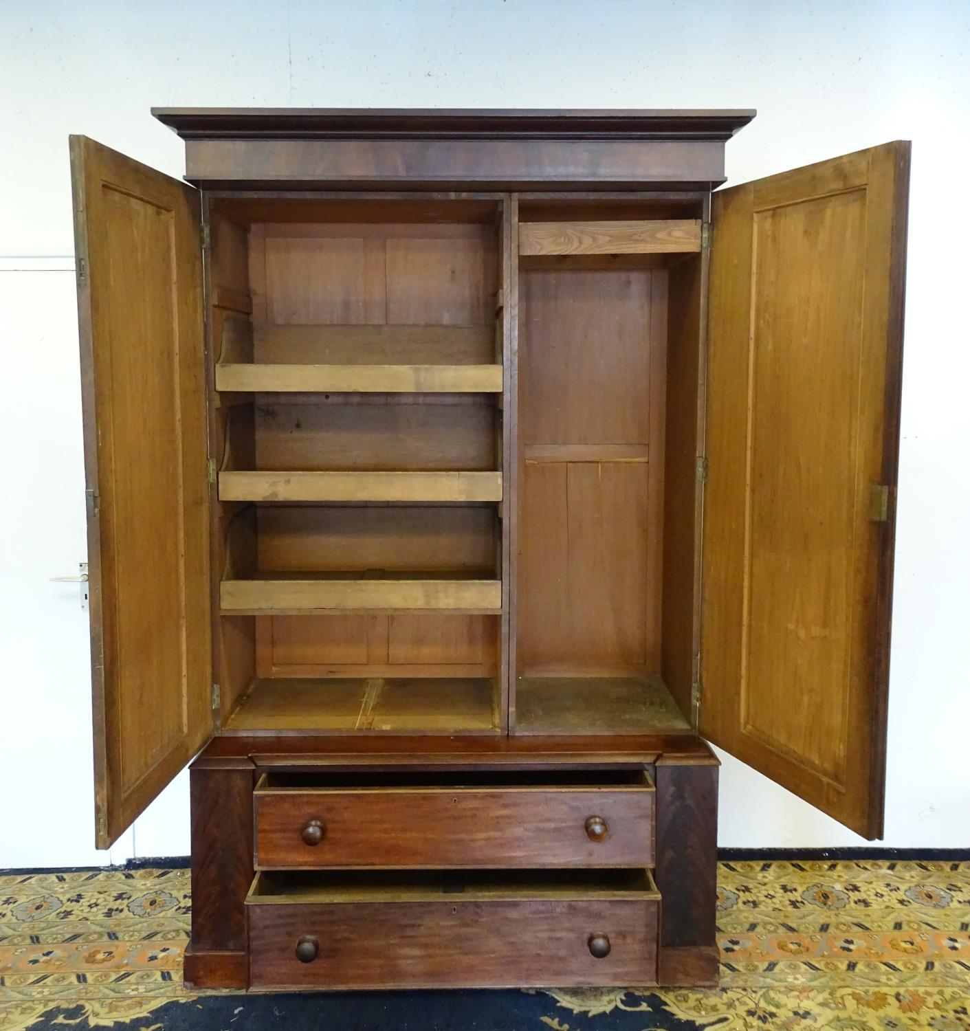 A 19thC mahogany press with a moulded cornice above two large doors with lancet shaped panelling, - Bild 2 aus 7